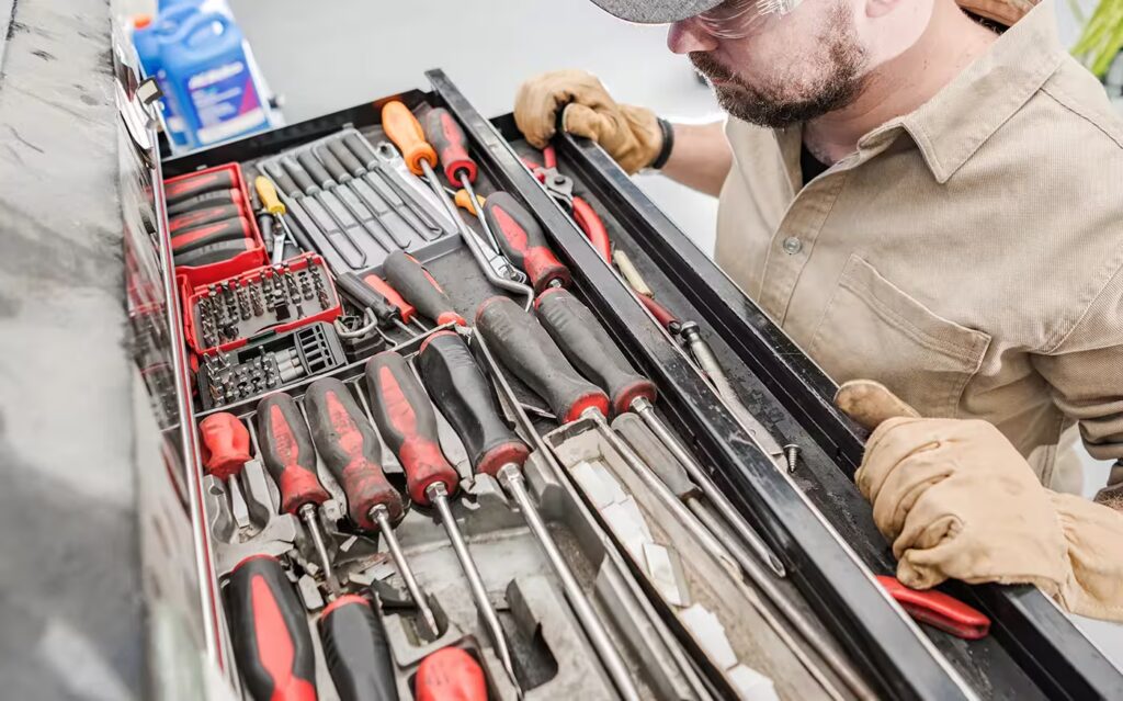 man reviews a toolbox